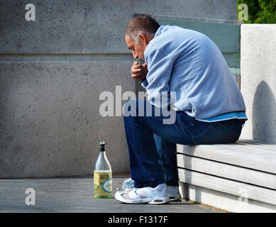 Mann mit Zigarette und Wein Flasche im Freien. Stockfoto