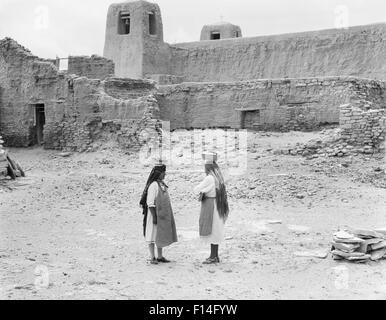 1930ER JAHREN ZWEI INDIANISCHEN FRAUEN IN SKY CITY DIE ÄLTESTE STÄNDIG BEWOHNTE STADT IN NORDAMERIKA ACOMA PUEBLO NEW MEXICO USA Stockfoto