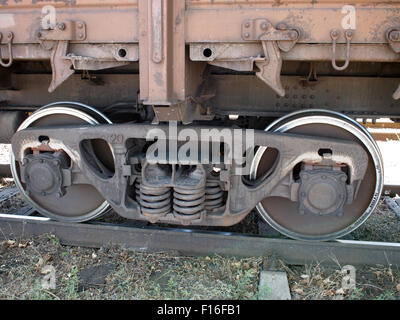 Detail-Nahaufnahme von einem Eisenbahnwaggon - das Rad, das Unterteil des Autos und der Strecke Stockfoto