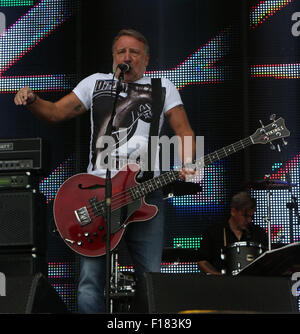 Portsmouth, Hampshire, UK. 29. August 2015. Siegreiche Festival Samstag Peter Hook und The Light auf der großen Bühne, als der Regen fällt. © UKNIP Stockfoto