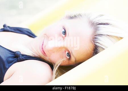 Porträt einer jungen blonden Frau mit großen blauen Augen Stockfoto