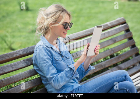 Schöne blonde Frau mit elektronischen Tablet in Händen Stockfoto