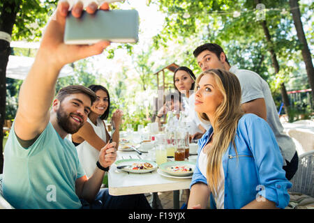 Porträt von einem Freunde machen Selfie Foto auf Smartphone im Restaurant unter freiem Himmel Stockfoto