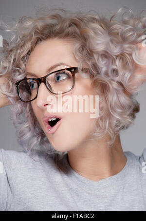 Eine weiße europäische Frau Alter 20-25 mit Brille. Der Schuss ist eine Porträtaufnahme in einem Studio. Stockfoto