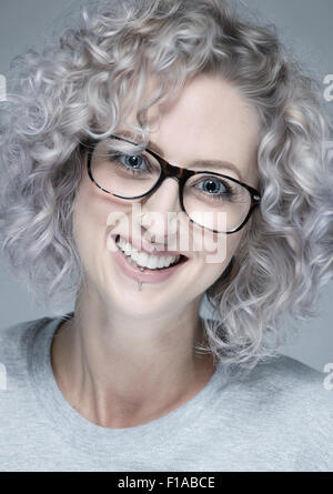 Eine weiße europäische Frau Alter 20-25 mit Brille. Der Schuss ist eine Porträtaufnahme in einem Studio. Stockfoto