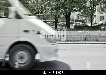 Verschwommene weiße Auto in Bewegung auf dem Stadt-boulevard Stockfoto