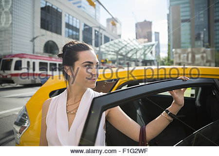 Geschäftsfrau aus dem Taxi in die Stadt