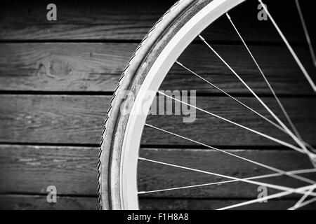 Transport-Stillleben. Nahaufnahme des Fahrrad-Rad vor Holzwand, Schweden. Stockfoto