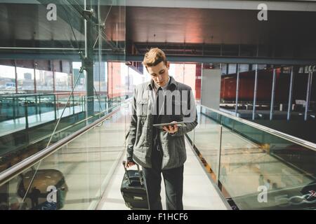 Porträt der jungen Geschäftsmann Pendler mit digital-Tablette am Bahnhof. Stockfoto