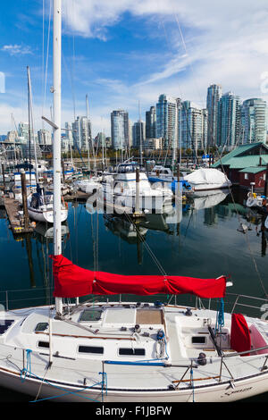 Kleine Yacht mit einem leuchtend roten Segel Abdeckung in einer Marina auf False Creek, Vancouver Stockfoto