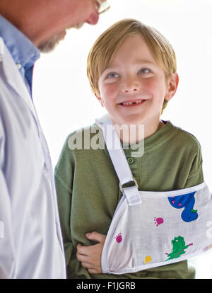 Verletzten Kind lächelt an seinem Arzt Stockfoto