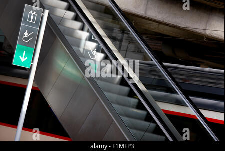 Wegweiser und Fahrtreppen in einem horizontalen Bahnhof Stockfoto