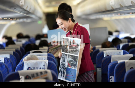 (150905)--Peking, 5. September 2015 (Xinhua)--A Flight Attendant zeigt Fotos von Peking Day Parade auf dem Flug CZ6366 von Peking, Hauptstadt von China, nach Haikou, der Hauptstadt der Provinz Süd-China Hainan, 5. September 2015. China Southern Airlines begann eine Veranstaltung namens "In Gedenken an Peking Day Parade" auf einem Flug von Beijing-Haikou Samstag, Parade Fotos für Passagiere. China am Donnerstag statt Gedenken Aktivitäten, einschließlich einer großen Militärparade anlässlich der 70. Jahrestag des Sieges von dem chinesischen Volk Krieg des Widerstands gegen die japanische Aggression und die Wor Stockfoto