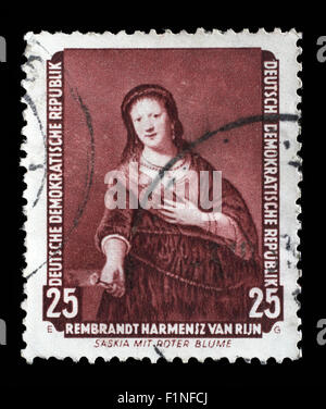 Gedruckt in DDR Stempel zeigt das Gemälde Saskia mit roter Blume, von Rembrandt, ca. 1957. Stockfoto