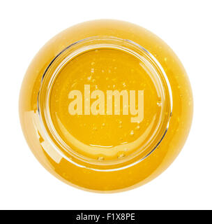 Glas mit goldenen Honig auf dem weißen Hintergrund isoliert. Stockfoto