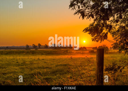 Landschaft in ein nebliger Morgen mit einem Sonnenaufgang Stockfoto