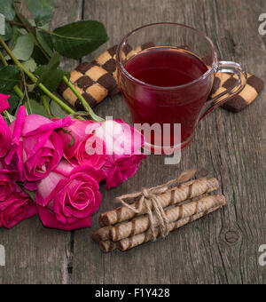 Tasse Tee, Strauß Rosen und verschiedene cookies Stockfoto