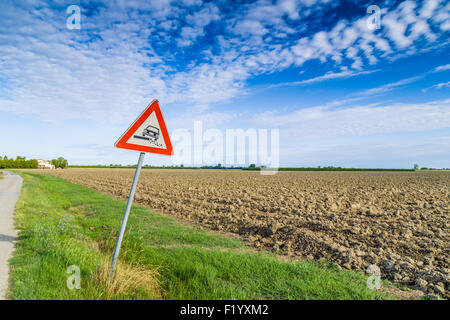 Gefährliche Schulter Ruropean Schild Kiesweg in italienischen Landschaft am Himmelshintergrund Stockfoto