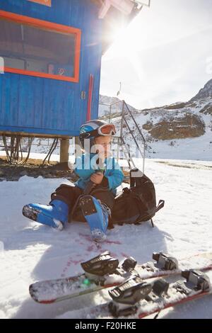 Junge Skifahrer sitzen auf Rucksack Essen Snack, Neustift, Stubaital, Tirol, Österreich Stockfoto