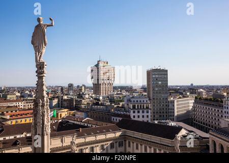 Italien, Lombardei, Mailand, ein Pfeil und Statue von Dom seit der Terrasse auf dem Dach der Kathedrale mit Blick auf den Turm Velasca gesehen Stockfoto