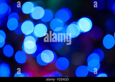 Eine blaue Farbe Bokeh Hintergrund erstellt durch eine Reihe von de-fokussierten Weihnachtsbeleuchtung. Stockfoto