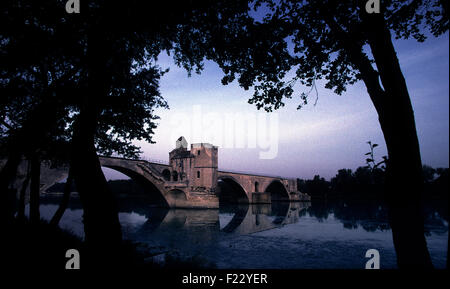 Die Pont d ' Avignon, Pont Saint-Bénézet bei Dämmerung, Avignon, Südfrankreich.  2000 the Pont Saint-Bénézet (französische Aussprache: [Pɔ̃ Sɛ̃ Benezɛ]), auch bekannt als die Pont d ' Avignon (IPA: [Pɔ̃ Daviɲɔ̃]), ist eine berühmte mittelalterliche Brücke in die Stadt Avignon in Südfrankreich. Eine Brücke über die Rhône zwischen Villeneuve-Lès-Avignon und Avignon wurde 1177 bis 1185 errichtet. Diese frühen Brücke wurde vierzig Jahre später während der Albigenserkriege zerstört, als Louis VIII von Frankreich Belagerung nach Avignon gelegt. Die Brücke wurde mit 22 Steinbögen umgebaut. Es war sehr aufwendig zu pflegen wie die Bögen sind in der Regel Stockfoto