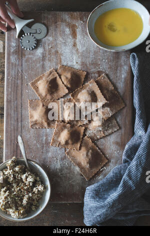 Das Kochen von Kastanienmehl Ravioli mit Artischocken, Erbsen und Enoki Pilze. Stockfoto