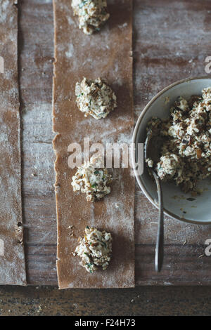 Das Kochen von Kastanienmehl Ravioli mit Artischocken, Erbsen und Enoki Pilze. Stockfoto