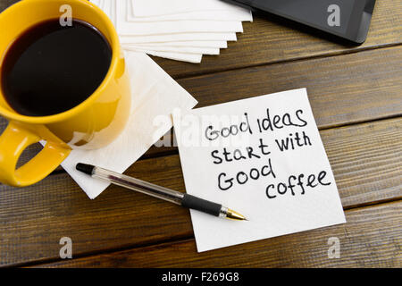 Super Ideen beginnen mit guten Kaffee - Handschrift auf einer Serviette mit einer Tasse Kaffee Stockfoto