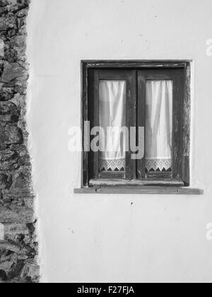 Schwarz / weiß Bild der alten Fenster Haus mit traditionellen Vorhängen Stockfoto