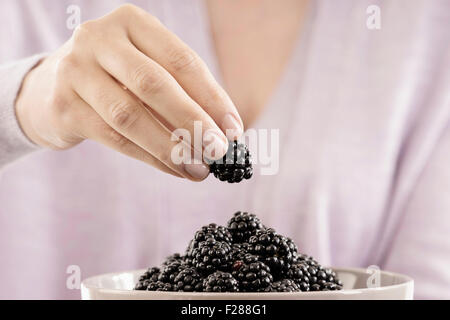 Mitte Schnittansicht Frau Essen Brombeere, Bayern, Deutschland Stockfoto