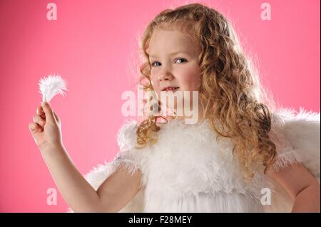 Schöne Engel Mädchen hält eine Feder Stockfoto