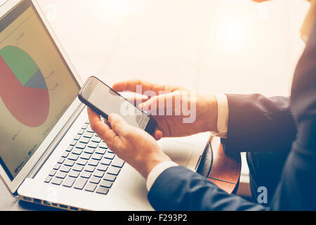 Geschäftsmann mit einem tragbaren Informationen Gerät Stockfoto