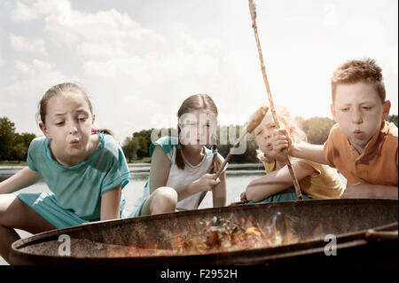 Gruppe von Freunden vorbereiten Würstchen am Lagerfeuer, Bayern, Deutschland Stockfoto