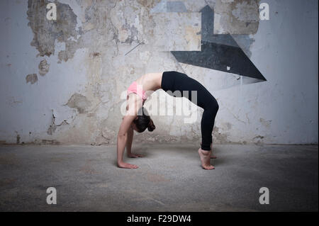 Mitte Erwachsene Frau üben Brücke stellen im Yoga-Studio, München, Bayern, Deutschland Stockfoto