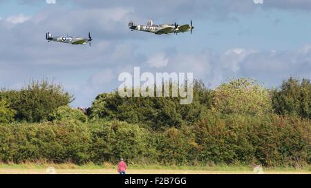 Mitglieder der Öffentlichkeit beobachten Spitfires und andere Flugzeuge des zweiten Weltkriegs zu der von Goodwood Flugplatz in der Nähe von Chichester Stockfoto
