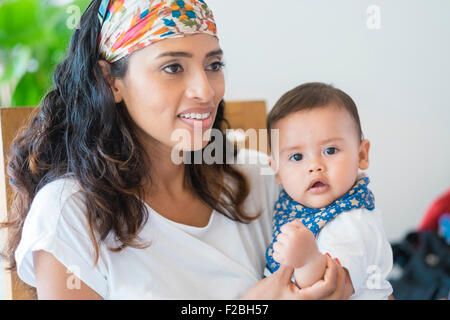 Ethnische Mehrfamilienhaus - hispanic Frau mit Baby Sohn auf dem Schoß Stockfoto