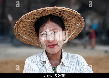 Frau trägt einen Strohhut und Thanaka Paste auf ihr Gesicht, Lächeln, Porträt, Ngapali Thandwe, Rakhine State in Myanmar Stockfoto