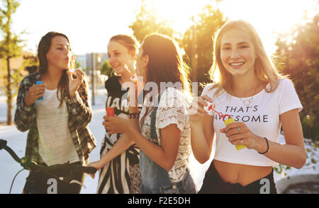 Gruppe von Freunden draußen rumhängen und lachen Stockfoto