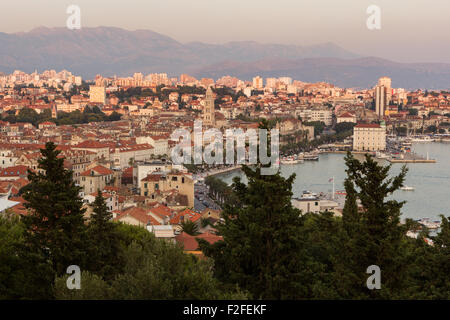 Blick auf Split Hafen, Altstadt und darüber hinaus von oben in Kroatien bei Sonnenuntergang. Stockfoto