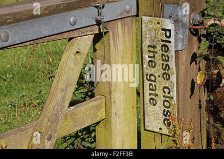 Zeichen auf einer Säule sagen schließen bitte des Tores, Derbyshire, UK Stockfoto