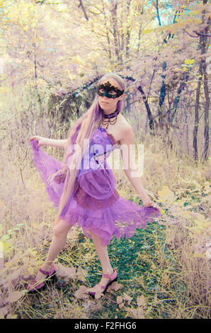 Full Length Portrait Frau mit komplizierten Maske und Kleid zu Fuß draußen in Wald - Porträt des mythischen suchen Stockfoto