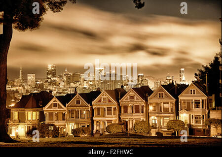 Zeile des viktorianischen Häusern an der Steiner Street gegen die Skyline in San Francisco. Stockfoto