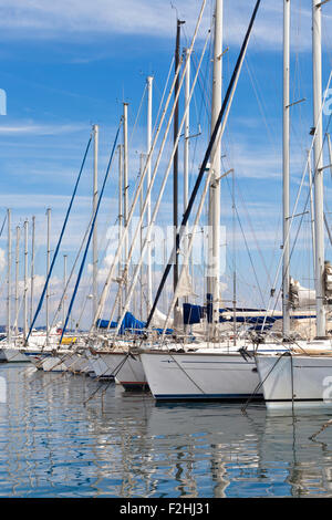Zeile Segelboote vor Anker in der Cote d ' Azur-Saint-Tropez Marina an einem sonnigen Sommertag mit Zick-Zack-Spiegelungen im Wasser Stockfoto