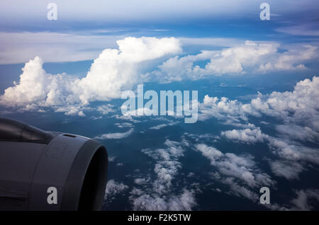 Blick aus dem Flugzeugfenster: Wolken und Triebwerk über Mexico City, Mexiko | MEXICO CITY, Mexiko — Ein Triebwerk und Flügel schneiden durch eine Decke aus Kumuluswolken, während das Flugzeug auf Mexico City herabsinkt. Mit etwa 7.350 Fuß (2.240 m) im Tal von Mexiko gelegen, zählt Mexico City zu den höchstgelegenen Großstädten der Welt, und das umgebende Bergbecken fängt oft eine dichte Wolkendecke wie diese ein. Die Triebwerksverkleidung rahmt eine klassische Aussicht aus dem Fensterplatz ein. Stockfoto