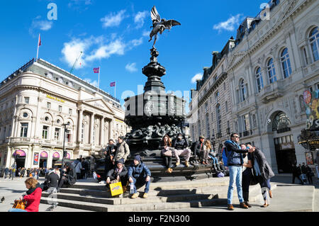 Touristen auf den Stufen des Shaftesbury Memorial Fountain oder Eros, unter der Statue von Anteros, Piccadilly Circus, City of Westminster, London, England, VEREINIGTES KÖNIGREICH Stockfoto