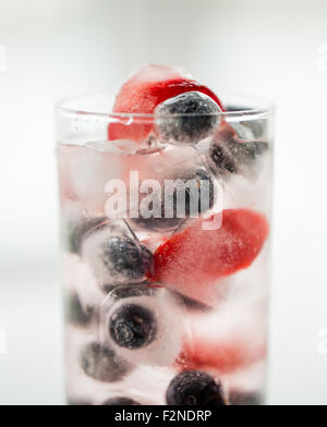 Nahaufnahme von Obst Wasser mit Eiswürfeln in Glas Stockfoto