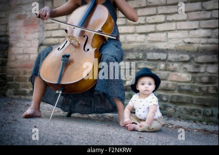 Gemischte Rassen Musiker spielt Cello mit Tochter Stockfoto