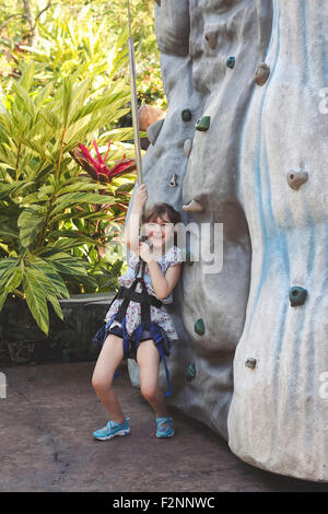 Kaukasische Mädchen Rock Kletterwand im Kabelbaum Stockfoto