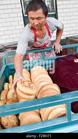 (150923)--TURPAN, 23. September 2015 (Xinhua)--Foto am 16. September 2015 zeigt Abduweli Rozi vorbereiten, Nang, eine Art von knusprigem Brot, an die Verkäufer in seiner Werkstatt in Turpan, Nordwesten Chinas Xinjiang Uygur Autonome Region zu verteilen. Fast jeden frühen Morgen 45-Year-Old Abduweli Rozi und seine Frau vor 03:00 aufwachen und beginnen ihre Arbeit. In den nächsten 10 Stunden würden sie 300 Nang zu machen und zu den Verkäufern in der Stadt verteilen. Dies ist nur ein Teil der Geschichte, die jeden Tag in einer kooperativen Gruppe von Nang Entscheidungsträger in Turpan nahm. Neben Abduweli Rozis Gruppierungsfunktion arbeiten 17 Familien t Stockfoto